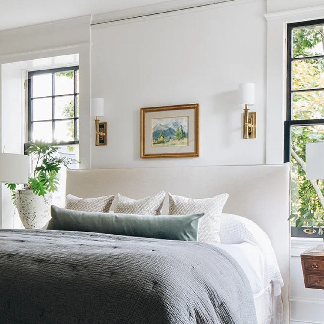 two walls sconces next to bed